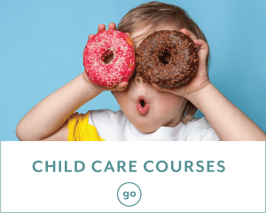 A child enjoying two donuts.